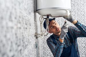 Plumber working on a water heater unit